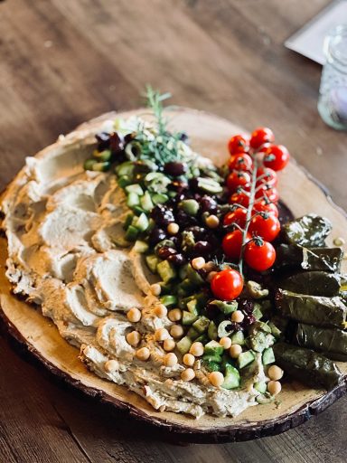 Hummus platter with assorted dips, crackers, and fresh vegetables